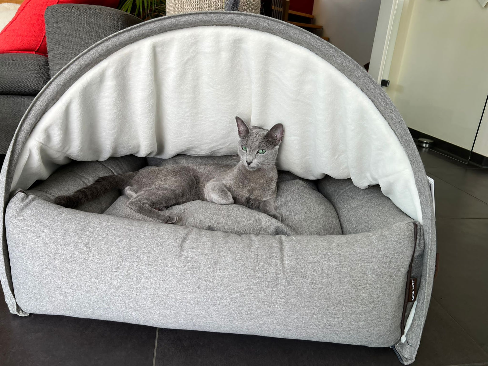 Russian Blue cat in a luxury KONA CAVE® cat cave bed in grey flannel. 