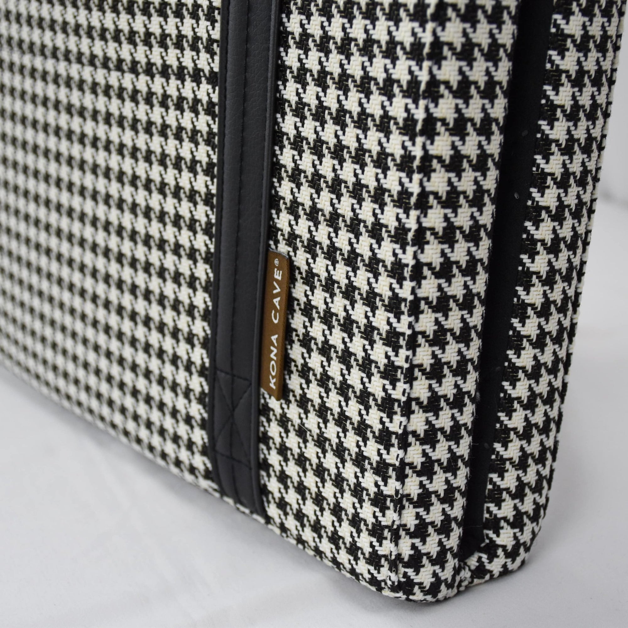 Close up of KONA CAVE® designer portable travel dog bed in black and white houndstooth fabric. Machine washable folded restaurant dog bed. 