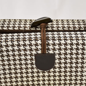 Close up of the convenient one-handed toggle closure in brown on the KONA CAVE® Travel  Dog Bed in brown and white houndstooth for restaurants and pubs. 