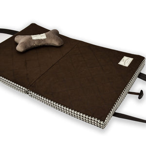 Luxury portable folded dog mat for restaurants. Shown open with brown quilted ultra-suede lining of the KONA CAVE® Travel Dog Bed with a velvet toy dog bone