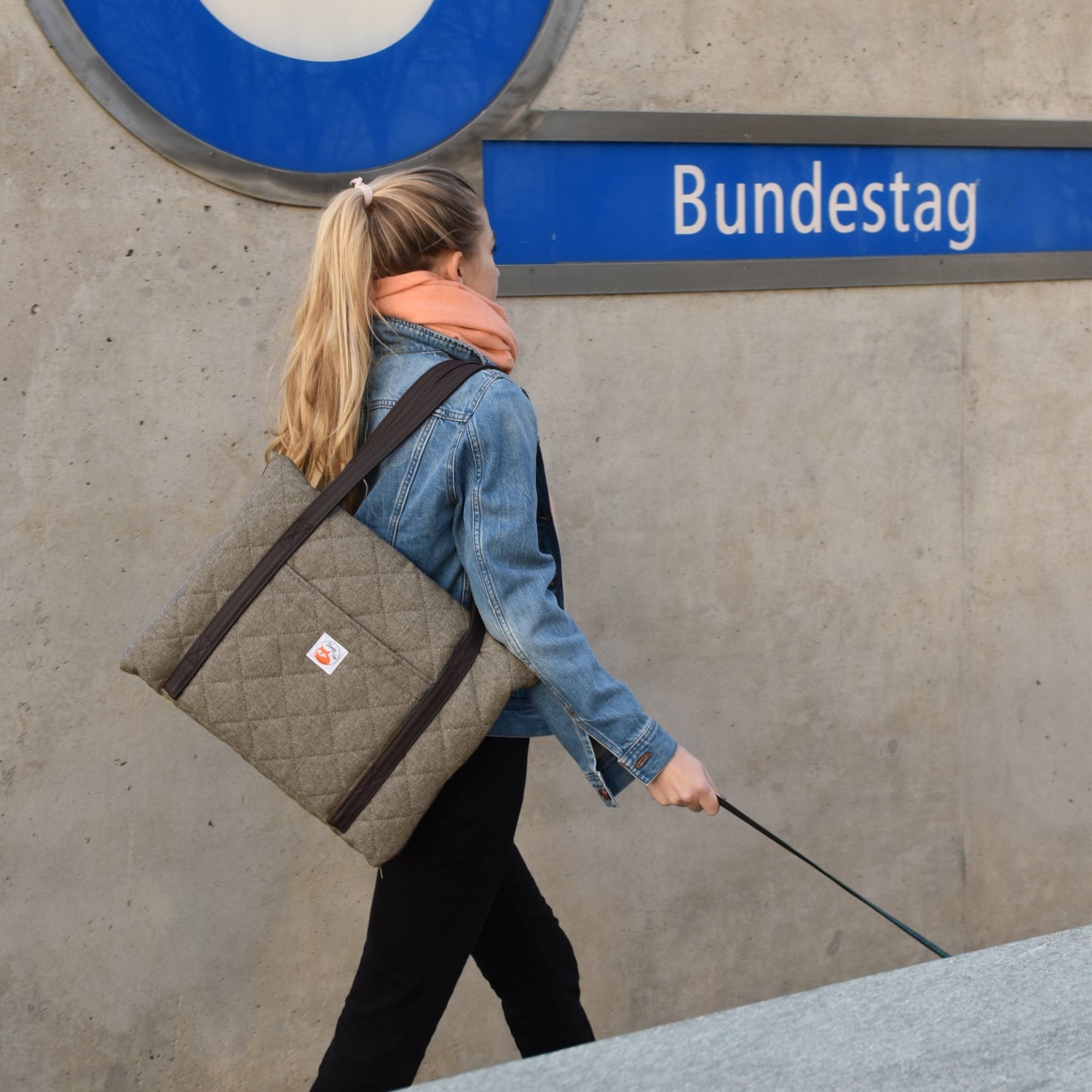 Restaurant dog bed. Portable dog bed. Folded, zips closed. Carried by long shoulder straps, handles. Ideal for restaurants. Beige. In Berlin. 