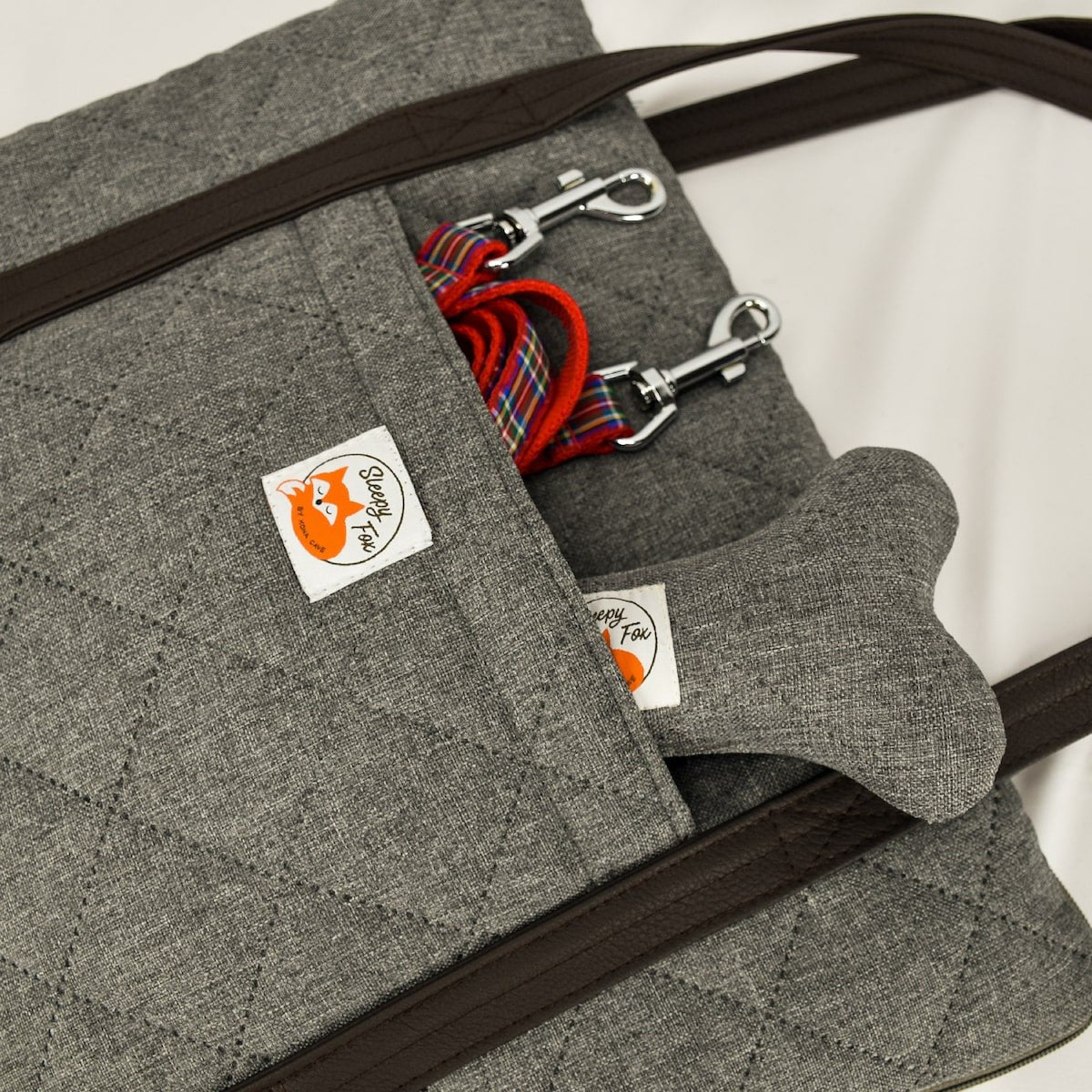 Restaurant dog bed. Portable dog bed. Folded, zips closed. Carried by long shoulder straps, handles. Ideal for restaurants with pocket.  
