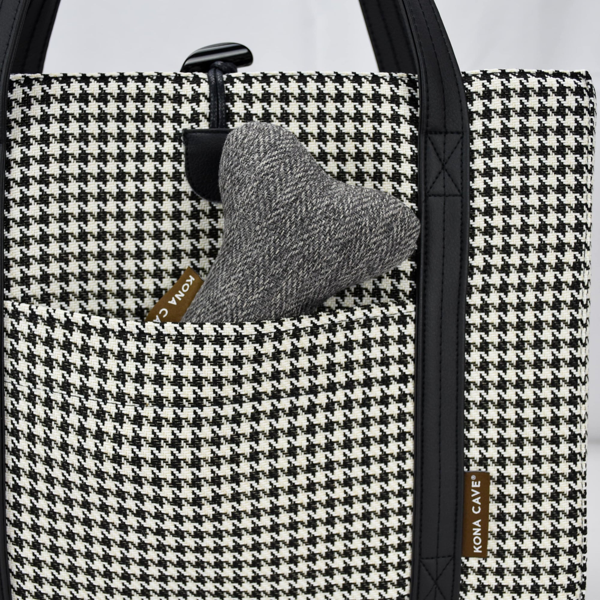 KONA CAVE® luxury Travel Dog Bed - Black and White Houndstooth with Black Quilted Alcantara faux suede lining, with front pocket for on-the-go dog essentials, vegan-leather shoulder straps, and toggle closure.  Portable, folded dog mat for restaurants, outside and hotels. City chic carried dog bed . Luxury toy dog bone in pocket. 