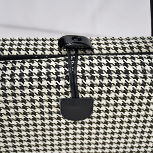 KONA CAVE® luxury Travel Dog Bed - Black and White Houndstooth with Black Quilted Alcantara faux suede lining, with front pocket for on-the-go dog essentials, vegan-leather shoulder straps, and toggle closure.  Portable, folded dog mat for restaurants, outside and hotels. City chic carried dog bed. Toggle closure for easy one handed closing. 